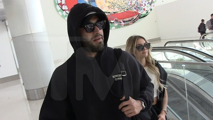 Sam Asghari Filmed With Britney Look-Alike Girlfriend at LAX Airport